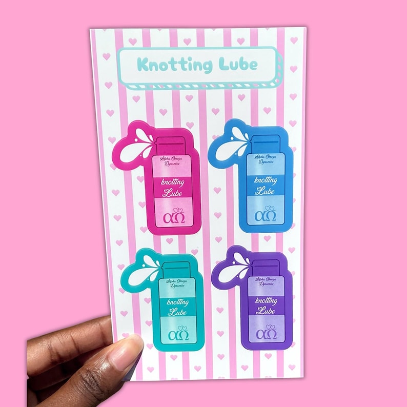 Puede incluir: Una hoja de pegatinas con cuatro dise&ntilde;os de botellas de Knotting Lube en rosa, azul, verde azulado y morado. El fondo es blanco con corazones y rayas rosas. El texto "Knotting Lube" est&aacute; en la parte superior. Cada botella tiene el texto "Knotting Lube".