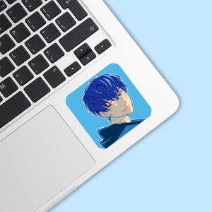 May include: A square sticker featuring an anime-style character with blue hair and red eyes. The character is set against a light blue background. The sticker is placed on a laptop.
