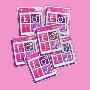 May include: A pile of pink and purple stickers with a holographic finish. Each sticker has a design like a computer window, with the letters "E", a male symbol, an exclamation mark, and a tick.