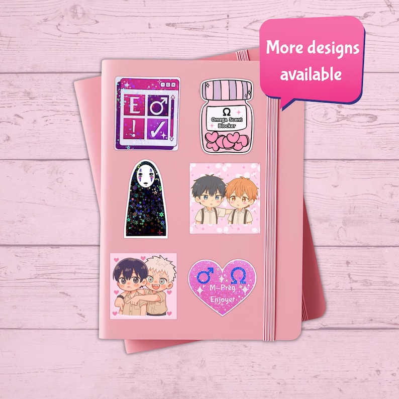 May include: A pink notebook adorned with various stickers. The stickers showcase anime-style illustrations and text, including a jar with hearts, a No-Face character, and a design with the text "M-Preg Enjoyer". A pink speech bubble says "More designs available".