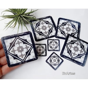 May include: Set of seven black and white patterned tile stickers. The stickers are various sizes and feature a geometric design with a central flower motif.