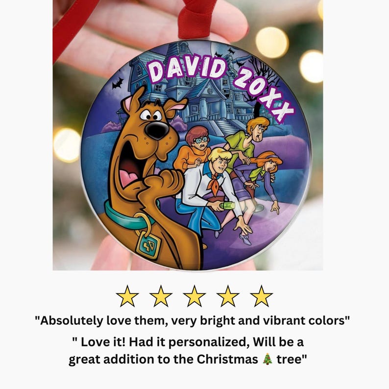 May include: A round Christmas ornament featuring the Scooby-Doo gang in front of a haunted house. The ornament has the name "DAVID" and the year "20XX" printed on it. The ornament is hanging from a red ribbon.
