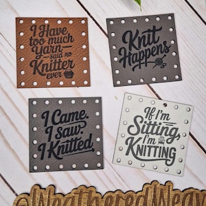 May include: Four square leatherette tags with humorous knitting quotes. The tags are brown, grey, and white, with black lettering and small white dots around the edges. The tags read: "I Have too much Yarn - said no Knitter ever", "Knit Happens", "I Came, I Saw, I Knitted", and "If I'm Sitting, I'm Knitting".