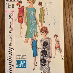 May include: Simplicity sewing pattern number 5309 for a sleeveless dress. The pattern is for a size 16 with a bust measurement of 36 inches. The pattern includes five different views of the dress, each with a different design. The designs include butterflies, sunflowers, and a cat. The pattern is printed on a white background with black text. The pattern is labeled "Simple to Sew".