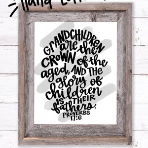 May include: A black and white hand-lettered quote on a white background with a gray watercolor wash. The quote reads "Grandchildren are the crown of the aged, and the glory of children is their fathers. Proverbs 17:6".