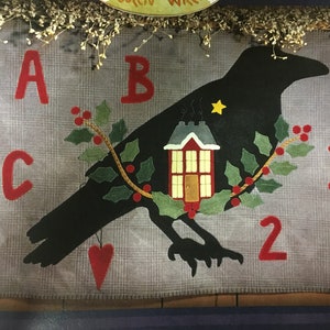 May include: A black crow silhouette with a small red house and holly branches on a gray background. The letters A, B, and C are in red felt, and the numbers 1, 2, and 3 are also in red felt.
