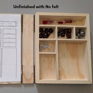 May include: Unfinished wooden box with compartments for dice and a miniature figure. The box is open and the compartments are empty except for the dice and figure. The box is made of light wood and has a natural finish. The text "Unfinished with No felt" is written on the top of the box.