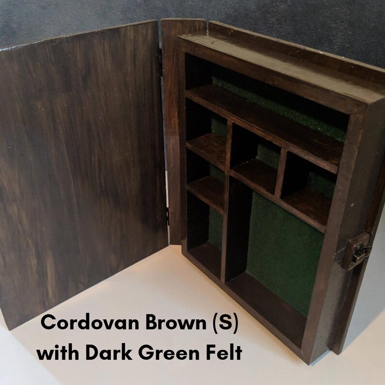 May include: A wooden box with a hinged lid, stained in a Cordovan Brown finish. The interior is lined with dark green felt and has multiple compartments.