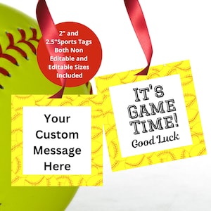 May include: A bright yellow softball with red stitching is next to two square gift tags hanging from red ribbons. One tag says "Your Custom Message Here," and the other says "IT'S GAME TIME! Good Luck."