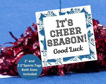 May include: Red and white cheerleading sign with the text "It's Cheer Season!" and "Good Luck". The sign is attached to a red pom-pom. The sign is available in 2 inch and 2.5 inch sizes.