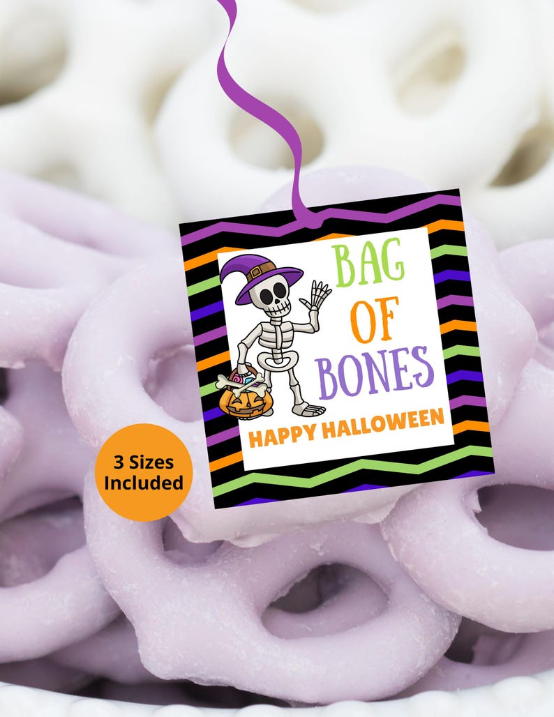 May include: A square Halloween gift tag featuring a cartoon skeleton wearing a purple witch hat and holding a pumpkin bucket. The text reads BAG OF BONES and HAPPY HALLOWEEN. The tag has a black border with colorful zig-zag stripes and a purple string.