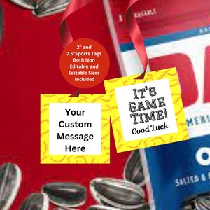 May include: Two yellow sports tags with baseball stitching and white text boxes. One tag reads "Your Custom Message Here," and the other says "IT'S GAME TIME! Good Luck." A red ribbon and sunflower seeds are in the background.