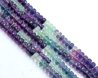 May include: A strand of faceted gemstone beads in shades of purple, green, and blue. The beads are arranged in a repeating pattern, creating a colorful and eye-catching design.