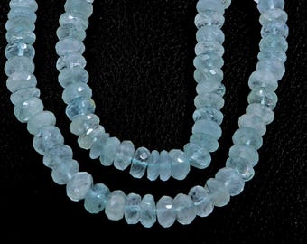 May include: Two strands of light blue aquamarine beads, each strand is made of faceted beads, the beads are strung together to form a necklace.