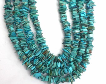 May include: A strand of turquoise chip beads, featuring a vibrant blue-green colour. The beads are irregularly shaped and have a natural, rustic look.