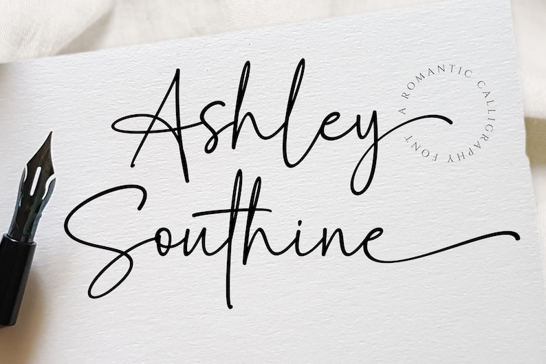 May include: A handwritten signature in black ink that reads "Ashley Southine" with a circular watermark that reads "A Romantic Calligraphy Font".