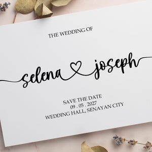 May include: A white save the date card with black text. The text reads "The Wedding of Selena & Joseph" with a heart symbol between the names. The date is 09.05.2027 and the location is "Wedding Hall, Senayan City".