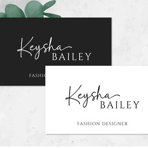 May include: Two business cards with a black and white design. The top card has a black background with white text that reads "Keysha Bailey" and "FASHION". The bottom card has a white background with black text that reads "Keysha Bailey" and "FASHION DESIGNER".