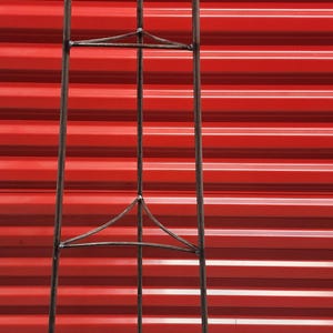 May include: A black metal plant stand with three tiers. The stand has a triangular base and is made of sturdy metal.