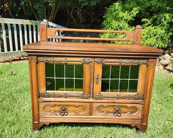 Gothic revival Antique small cabinet  tiger oak tv stand buffet green stain glass door front 2 draw Solid oak cast iron hinges