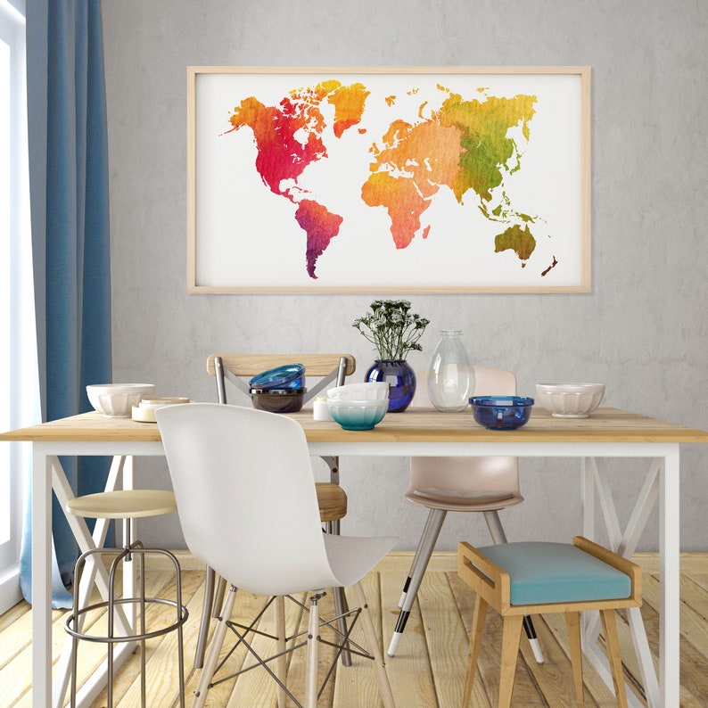May include: A white dining table with four chairs and a stool. The table has a wooden top and white metal legs. The chairs are a mix of styles, including a white plastic chair, a wooden chair with a metal frame, and a pink upholstered chair. There is a watercolour world map hanging on the wall behind the table.