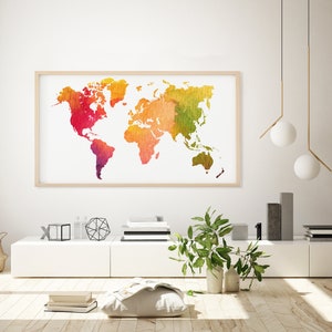 May include: A watercolour world map print in a wooden frame hangs on a white wall above a white shelf with decorative objects. The map is in shades of red, orange, yellow, and green.