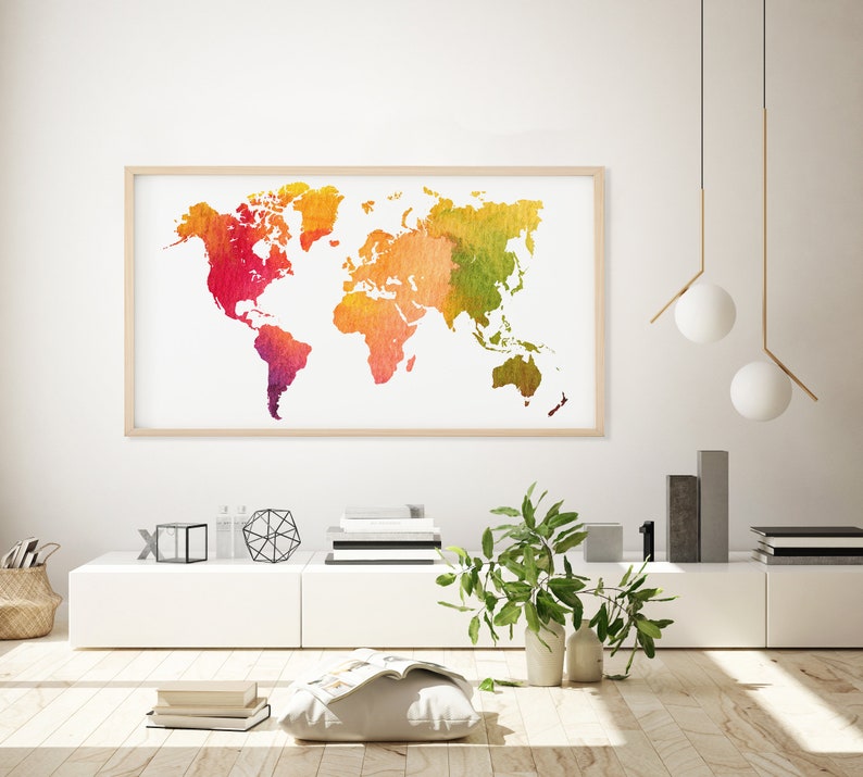 May include: A watercolour world map print in a wooden frame hangs on a white wall above a white shelf with decorative objects. The map is in shades of red, orange, yellow, and green.