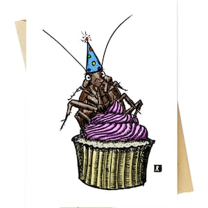 May include: A cockroach wearing a blue and white party hat sits on top of a pink and white cupcake. The cupcake is decorated with white frosting and has a brown paper liner.