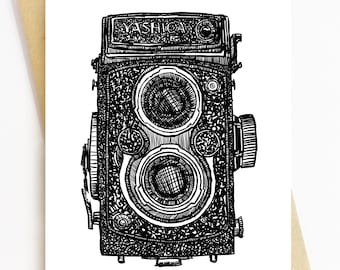 May include: Black and white illustration of a Yashica 124 G camera on a white card. The camera is a twin-lens reflex model, with detailed linework. The card is inside a brown envelope.