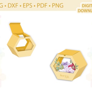 Puede incluir: Una caja hexagonal amarilla con una ventana, que presenta un diseño floral y el texto "Serra Original". La caja está abierta y la tapa está doblada hacia atrás.