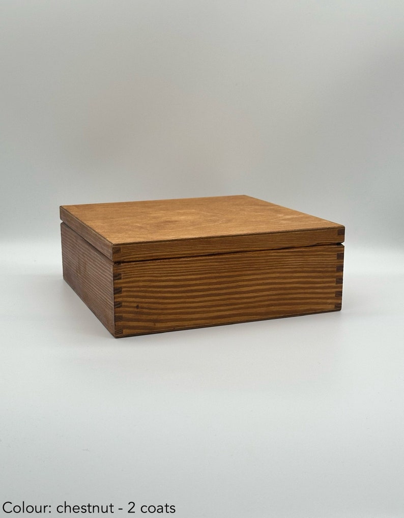 May include: A wooden box with a chestnut stain and two coats of finish. The box has a lid and is made of wood with a natural grain pattern.