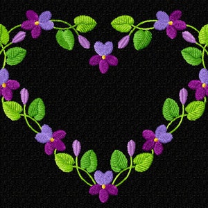 May include: Embroidered heart design featuring purple flowers, green leaves, and buds on a black background. The floral arrangement forms a heart shape, with each flower having a yellow center. The design is likely for embroidery or a similar craft project.