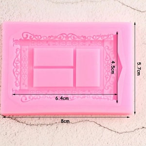 May include: A pink silicone mold with a rectangular shape, featuring an ornate border and three rectangular sections. The mold measures 8 cm long, 5.7 cm wide, and 4.5 cm high. The central sections are 6.4 cm long.