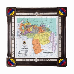 May include: A square wooden domino table featuring a central map of Venezuela with the text "REPUBLICA DE VENEZUELA" and "Fund La Guayaria Esequiba". The dark wood frame includes integrated domino score tracks and four circular Venezuelan flag accents.