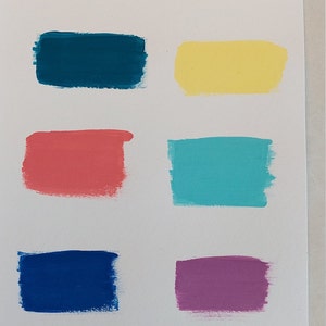 May include: Six paint colour swatches labelled "Coastal by Worn to Whimsy" and "Daydream Apothecary Paint". The colours are teal, yellow, coral, turquoise, blue, and purple.