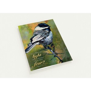 May include: A rectangular greeting card featuring an oil painting of a black-capped chickadee perched on a branch. The background is a textured blend of green and gold. The text reads: The LORD is my light and my salvation; whom shall I fear? PSALM 27:1.