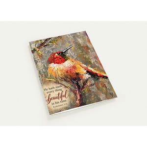 May include: A rectangular greeting card featuring an impasto-style oil painting of a hummingbird with red, orange, and yellow feathers perched on a branch. The text reads: He hath made every thing beautiful in his time. Ecclesiastes 3:11.