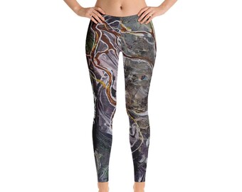 May include: Black leggings with a colourful abstract print featuring swirling lines and shapes in shades of brown, white, and grey.