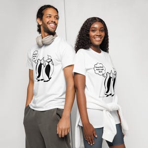 May include: White t-shirts with a penguin graphic. One shirt has the text "Many Minds Make Light Work" in a thought bubble. The other shirt has the text "Keep that light on" in a thought bubble. The shirts are worn by two people.