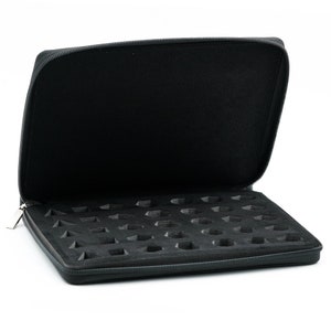 May include: Black zippered case with a foam interior featuring multiple compartments for storing small items.