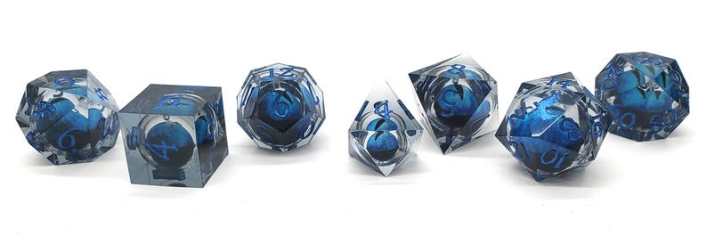 May include: Set of seven polyhedral dice with a blue and white design encased in clear resin. The dice include a cube, a d20, a d12, a d10, a d8, and two d6s. Each die has a different geometric shape.