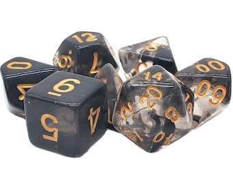 May include: A set of six black and gold dice with a swirl pattern. The dice are made of clear plastic with black swirls and gold numbers.