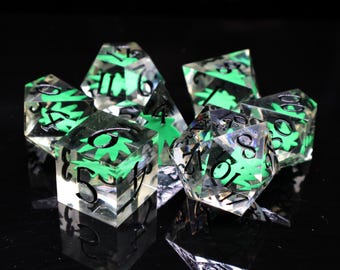 May include: A set of seven clear, multi-sided dice with black numbers and green leaf-like designs inside. The dice are arranged on a reflective black surface, creating a visually appealing display for tabletop gaming.