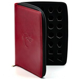 May include: A red leather dice bag with a zipper closure and a dragon logo. The inside of the bag has a black foam insert with cutouts for different shaped dice.