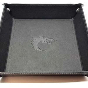May include: Black leather dice rolling tray with a dragon logo embossed on the bottom.