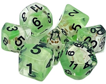 May include: A set of six green and white dice with black numbers. The dice are translucent and have a swirl pattern inside.