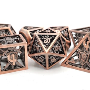 May include: A set of copper-colored, open-frame dice for tabletop games. The dice include various shapes, such as a d20, d12, d10, d8, d6, and d4. Each die features intricate designs and numbers, perfect for role-playing games.