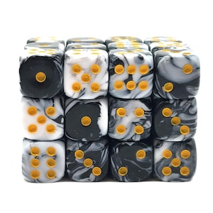 May include: A set of 16 black and white marbled dice with gold pips. The dice are arranged in a 4x4 grid.