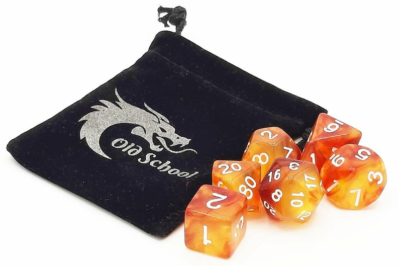 May include: A set of seven orange and yellow dice with white numbers, in a black velvet bag with a silver dragon logo that says "Old School".