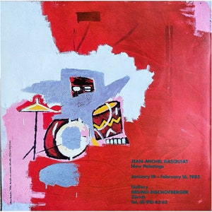 May include: A poster featuring a Jean-Michel Basquiat painting of a drum set in red, white, and yellow against a red background. Text includes: JEAN-MICHEL BASQUIAT, New Paintings, January 19-February 16, 1985, Gallery BRUNO BISCHOFBERGER, Zürich, Tel. 01/910 43 62.